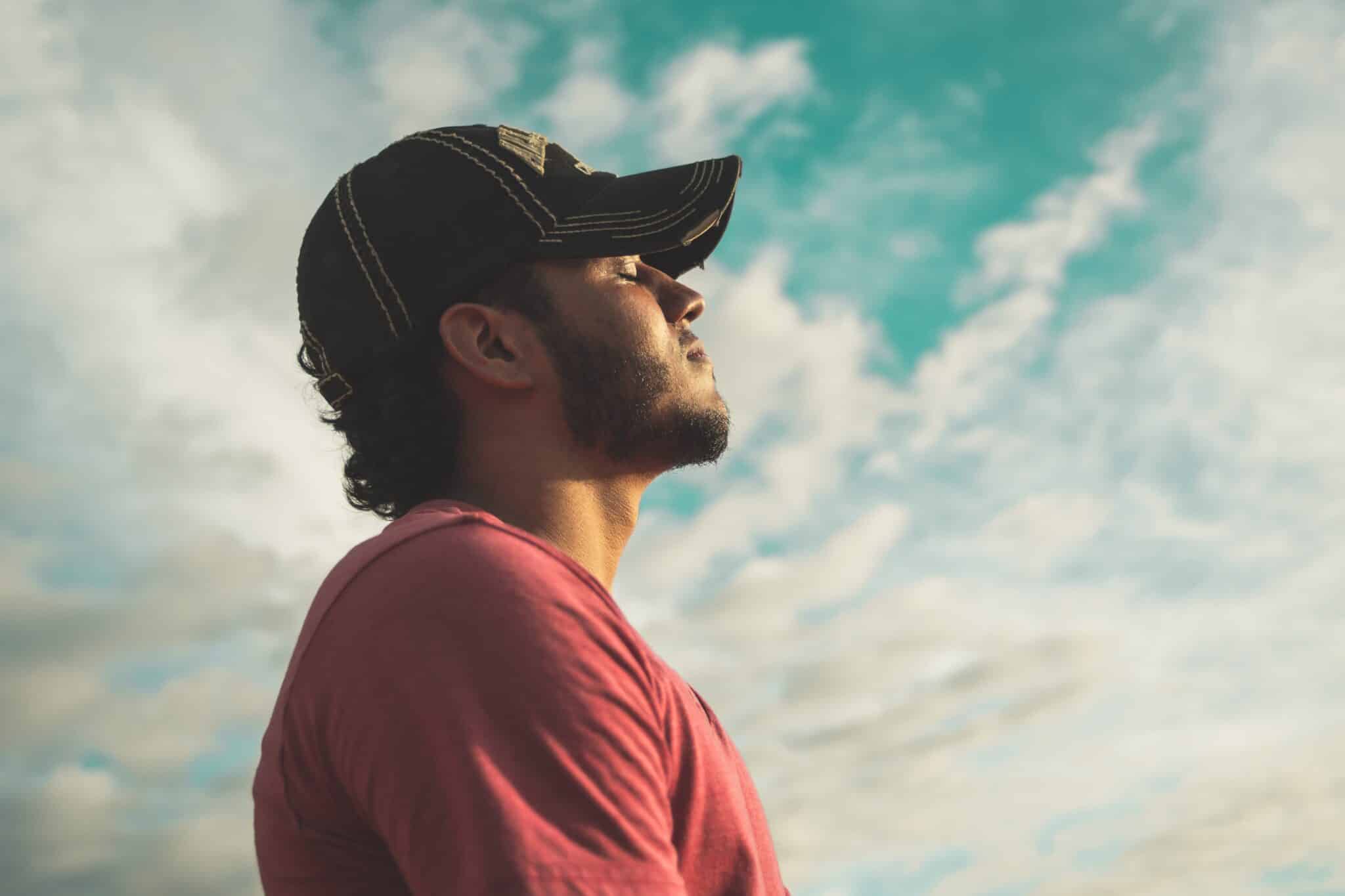 Man breathing deeply, cultivating a growth mindset for peace.